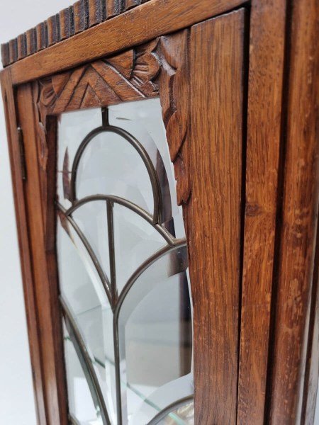 Detail van houtsnijwerk met bloemmotief op eikenhouten Art Deco vitrinekast